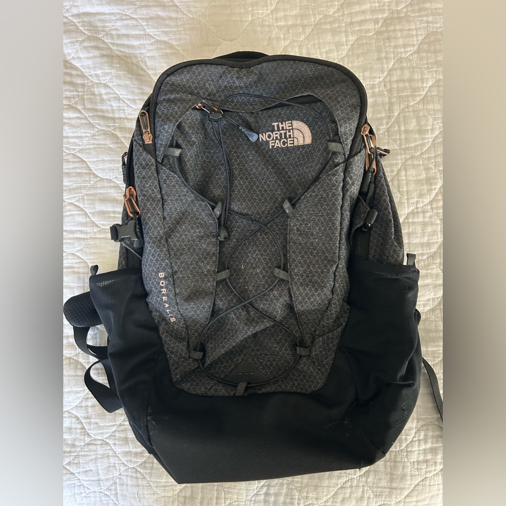 Northface black bookbag with rose gold zippers. Good condition but has been worn